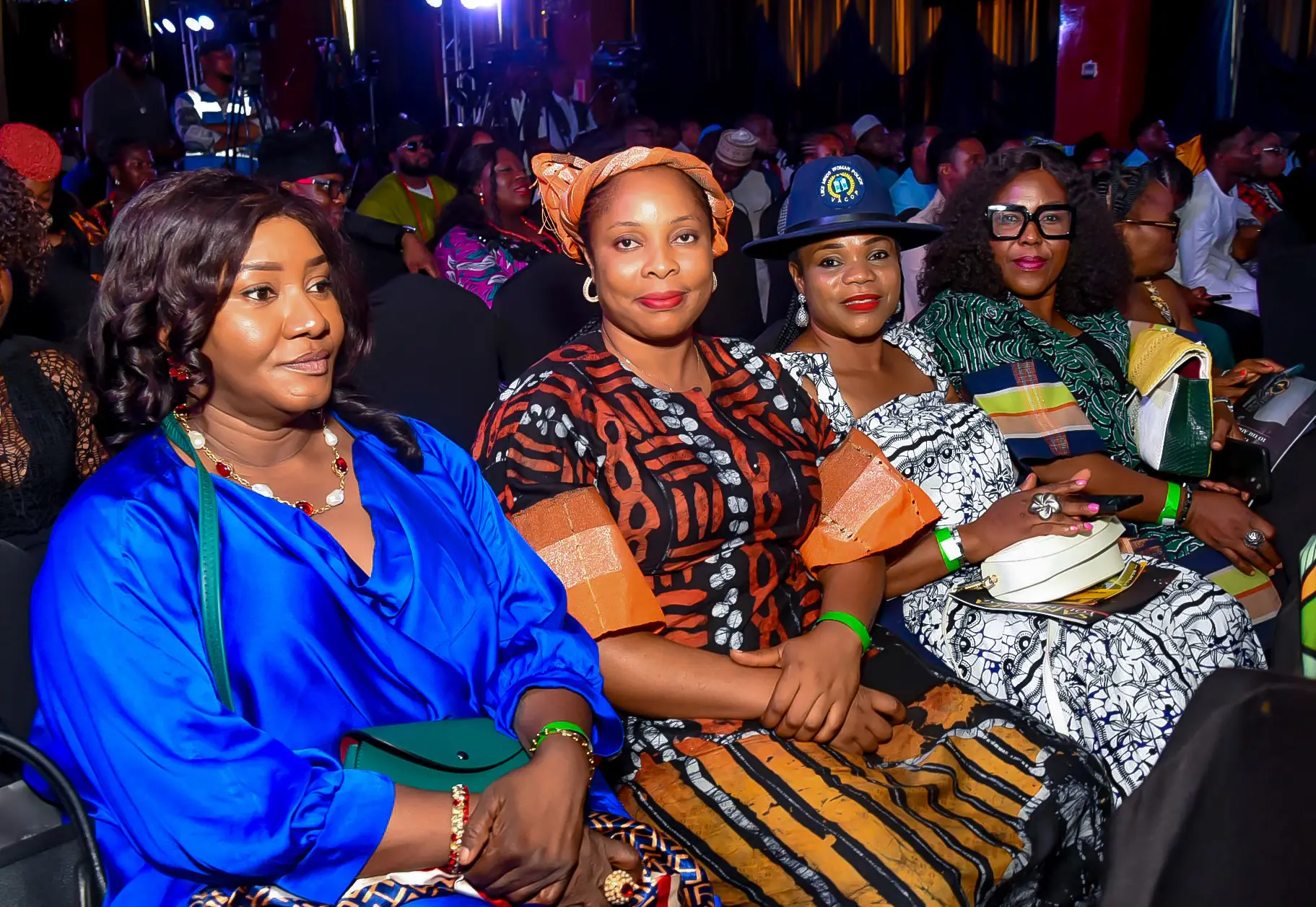 Women in colourful African dress seated in the audience